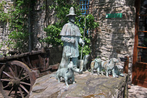 Stone statues of a shepherd with his dogs